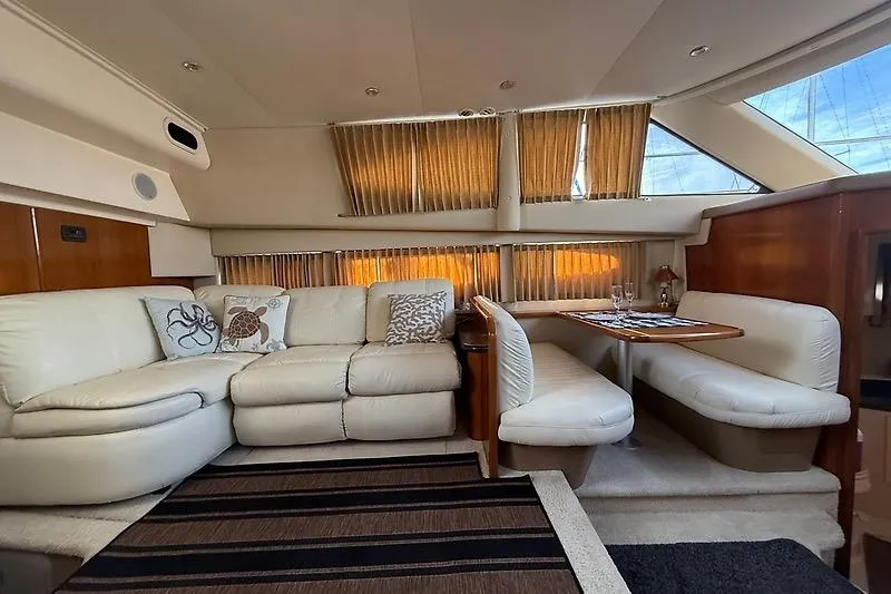 Slide: The Image of Luxurious interior of 2004 Carver 366 Motor Yacht with plush seating and dining area. - 13