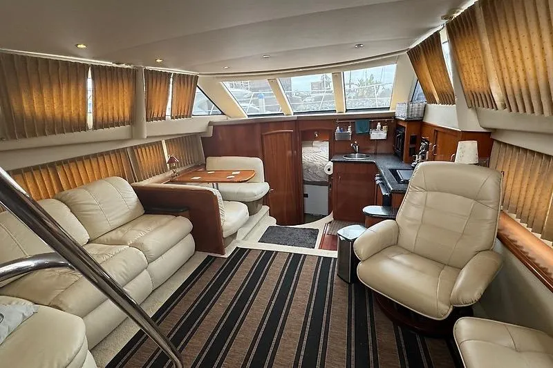 Slide: The Image of Luxurious interior of 2004 Carver 366 Motor Yacht with plush seating and elegant decor. - 15