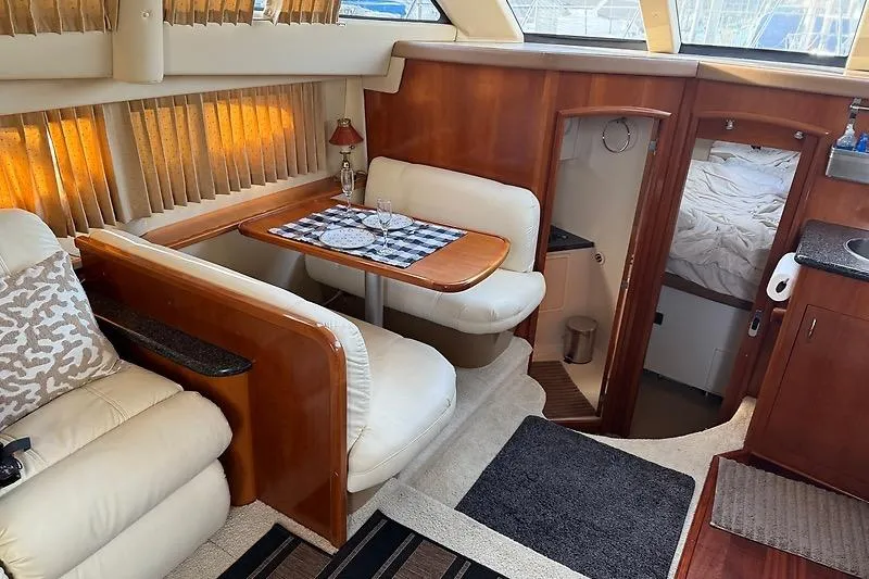 Slide: The Image of Interior of 2004 Carver 366 Motor Yacht with dining area and cozy cabin. - 17