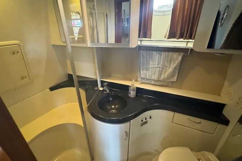 Slide: The Image of Bathroom interior of 2004 Carver 366 Motor Yacht with sink, mirror, and storage cabinets. - 22