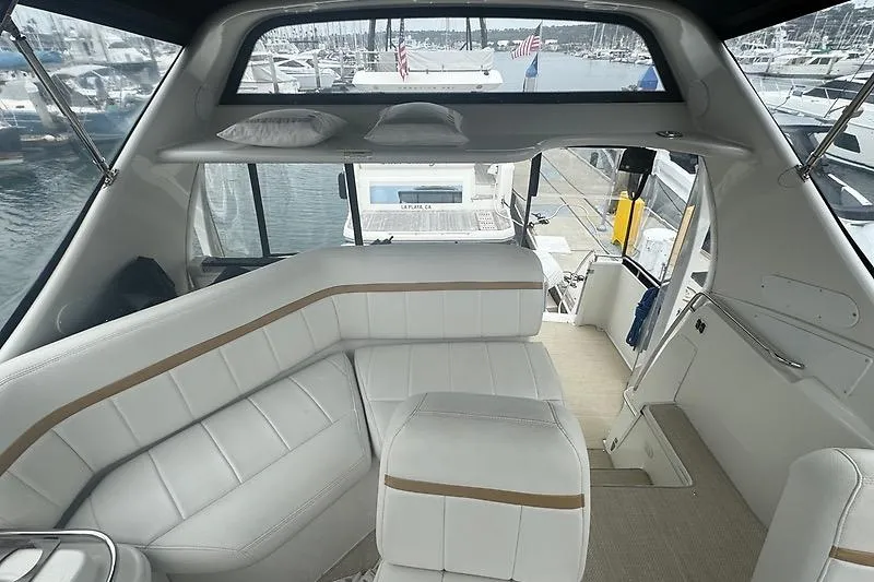 Slide: The Image of Interior of 2004 Carver 366 Motor Yacht with white seating and marina view. - 24