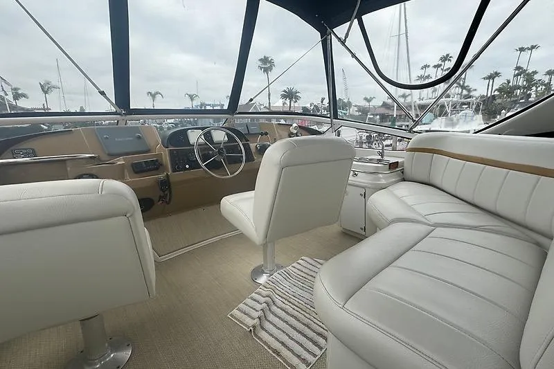 Slide: The Image of Interior view of 2004 Carver 366 Motor Yacht with white seating and helm. - 26