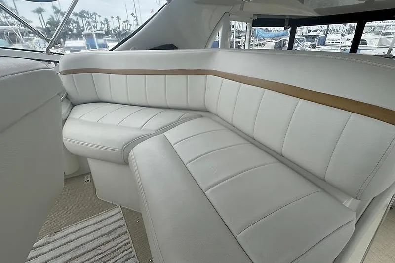 Slide: The Image of Luxurious white seating in 2004 Carver 366 Motor Yacht interior, with marina view. - 27