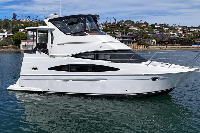 Slide: The Image of 2004 Carver 366 Motor Yacht on water, coastal background, clear sky. - 3
