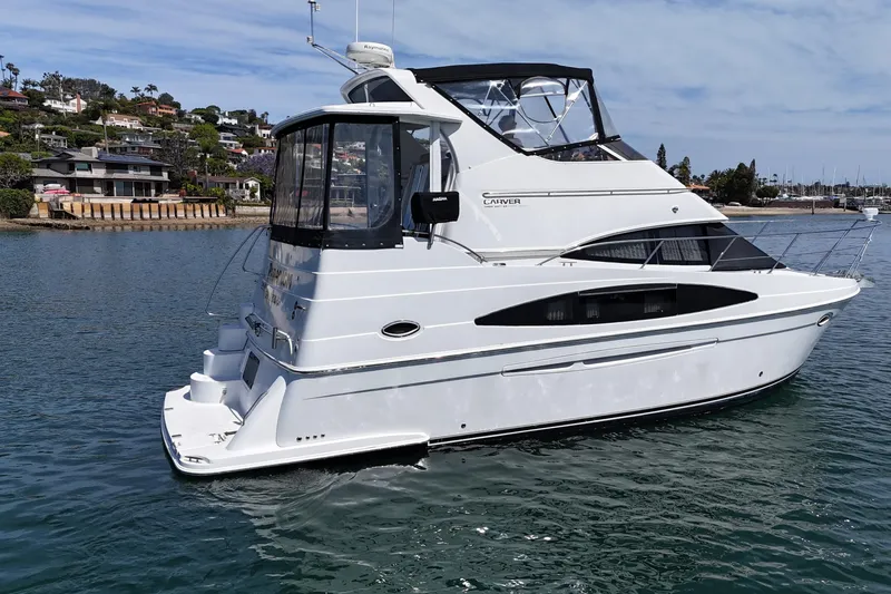 Slide: The Image of 2004 Carver 366 Motor Yacht cruising on a calm waterway near residential area. - 4