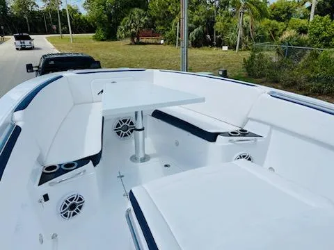 Slide: The Image of 2021 Nor-Tech 390 Center Console boat with white seating and table. - 3