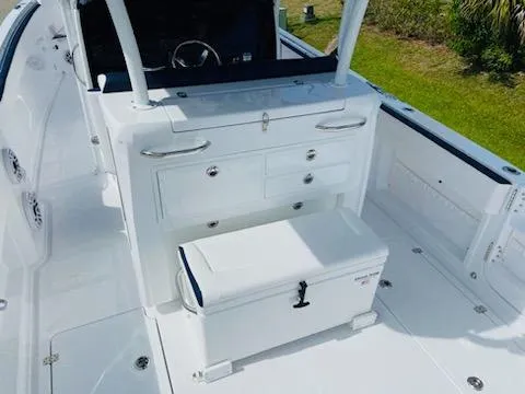 Slide: The Image of 2021 Nor-Tech 390 Center Console boat interior with storage compartments and seating. - 5