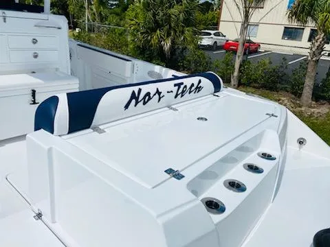 Slide: The Image of 2021 Nor-Tech 390 Center Console boat interior with seating and storage compartments. - 6