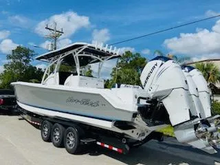 Slide: The Image of 2021 Nor-Tech 390 Center Console boat on a trailer with triple Mercury engines. - 9