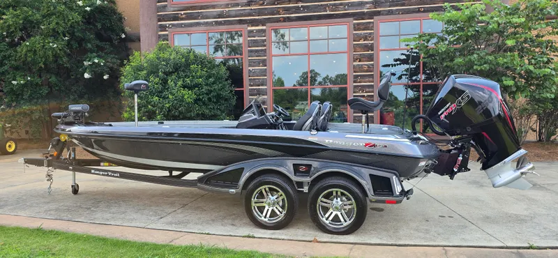 Slide: The Image of 2024 Ranger Z521R Ranger Cup Equipped boat on trailer, parked outdoors. - 1