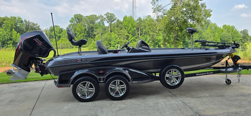Slide: The Image of 2024 Ranger Z521R Ranger Cup Equipped boat on trailer, parked outdoors. - 2