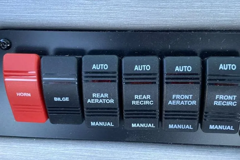 Slide: The Image of 2024 Ranger VS1782SC Reata control panel with switches for horn, bilge, aerators, and recirculators. - 12