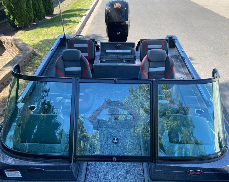 Slide: The Image of 2024 Ranger VS1782SC Reata boat with seating and windshield, parked on a street. - 13