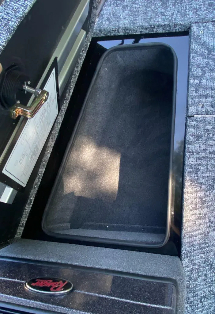 Slide: The Image of 2024 Ranger VS1782SC Reata storage compartment with a sleek, black interior. - 15