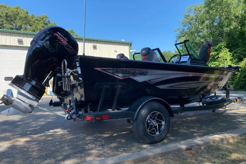 Slide: The Image of 2024 Ranger VS1782SC Reata boat on trailer, black exterior, parked outdoors. - 4