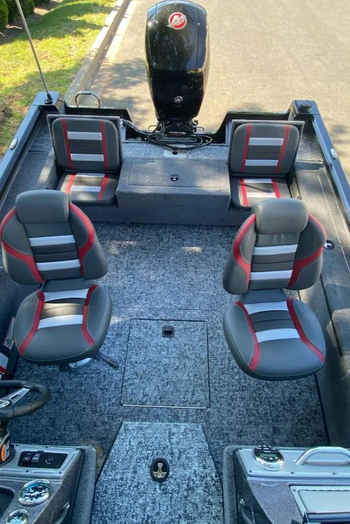 Slide: The Image of 2024 Ranger VS1782SC Reata fishing boat interior with seating and motor. - 7