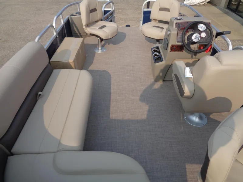 Slide: The Image of 2024 Sun Tracker Bass Buggy 18 DLX interior with beige seating and steering console. - 10
