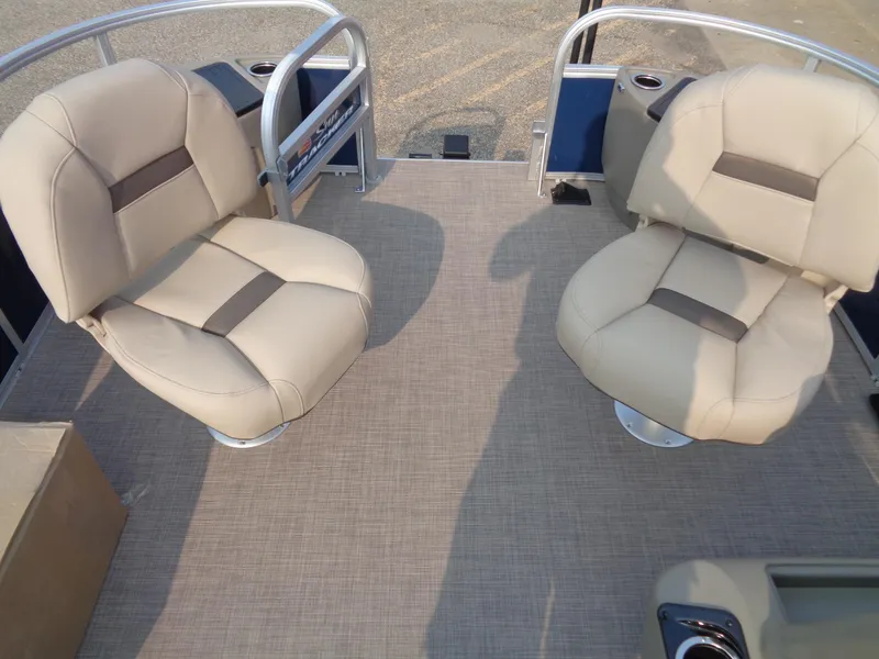 Slide: The Image of 2024 Sun Tracker Bass Buggy 18 DLX interior with two beige seats. - 11