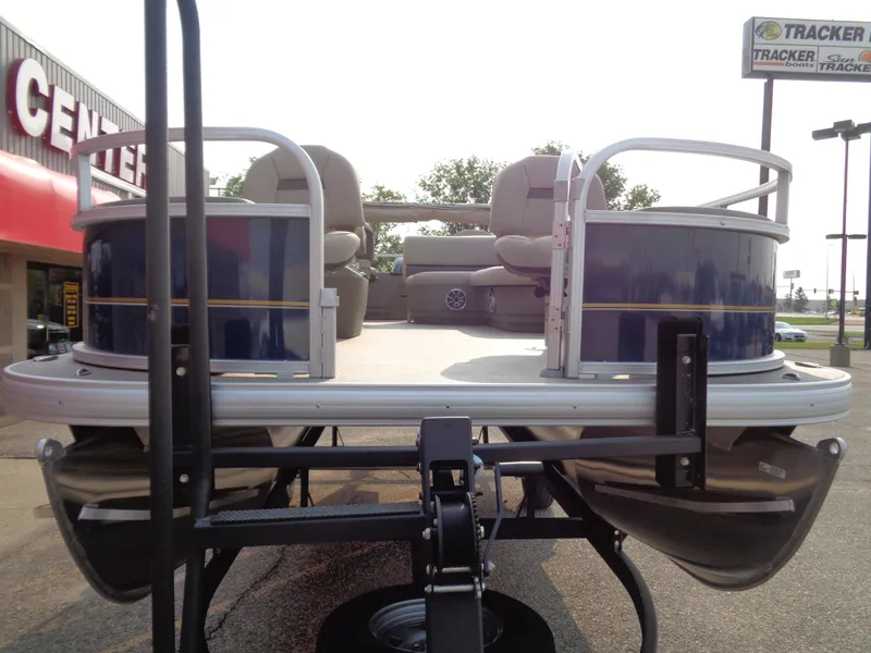 Slide: The Image of 2024 Sun Tracker Bass Buggy 18 DLX pontoon boat on display at dealership. - 9