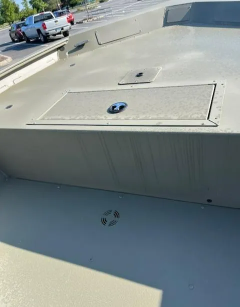 Slide: The Image of 2024 Tracker Grizzly 1754 Jon boat deck in a parking lot. - 2