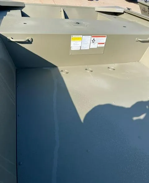 Slide: The Image of 2024 Tracker Grizzly 1754 Jon boat interior, showing storage area and safety labels. - 3