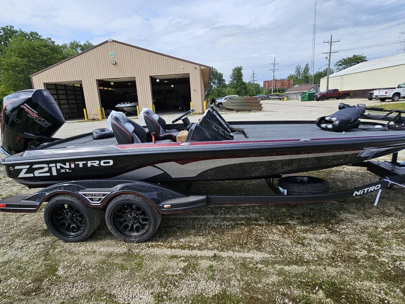 Slide: The Image of 2024 Nitro Z21 XL Pro bass boat parked outdoors. - 3