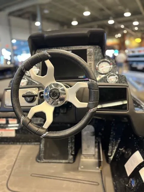 Slide: The Image of 2024 Nitro Z21 XL Pro boat dashboard with steering wheel and gauges. - 4