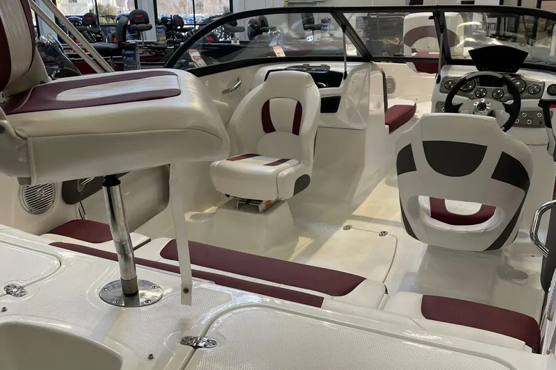 Slide: The Image of 2024 Tahoe 200 S boat interior with white and maroon seating, steering console, and modern design. - 3