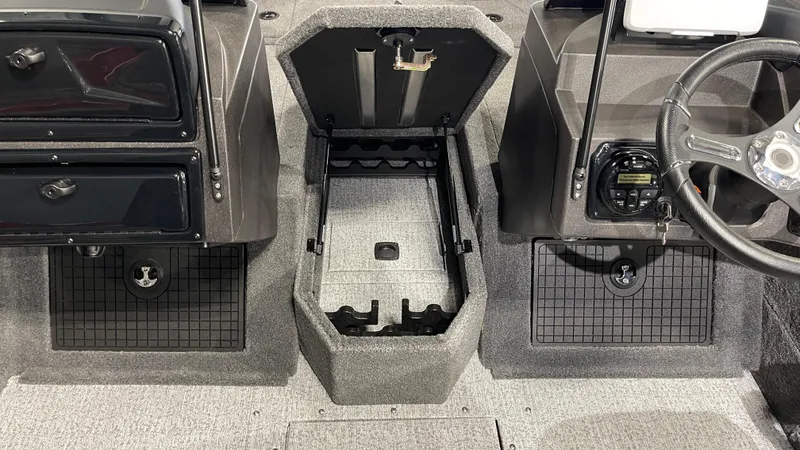 Slide: The Image of 2024 Tracker Targa V-19 WT boat interior with storage compartments and steering wheel. - 12