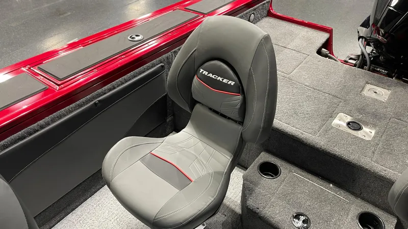 Slide: The Image of 2024 Tracker Targa V-19 WT boat seat, gray upholstery, red accents, and carpeted flooring. - 16