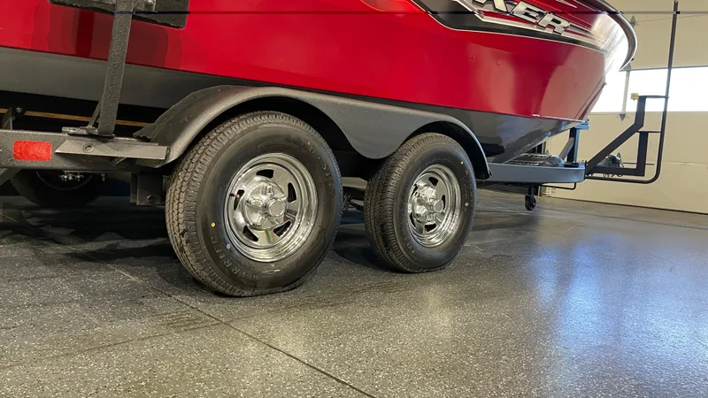 Slide: The Image of 2024 Tracker Targa V-19 WT boat on trailer, featuring dual wheels in a garage setting. - 7
