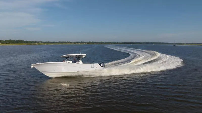 Slide: The Image of 2025 Sea Fox 368 Commander Center Console boat cruising on open water. - 2