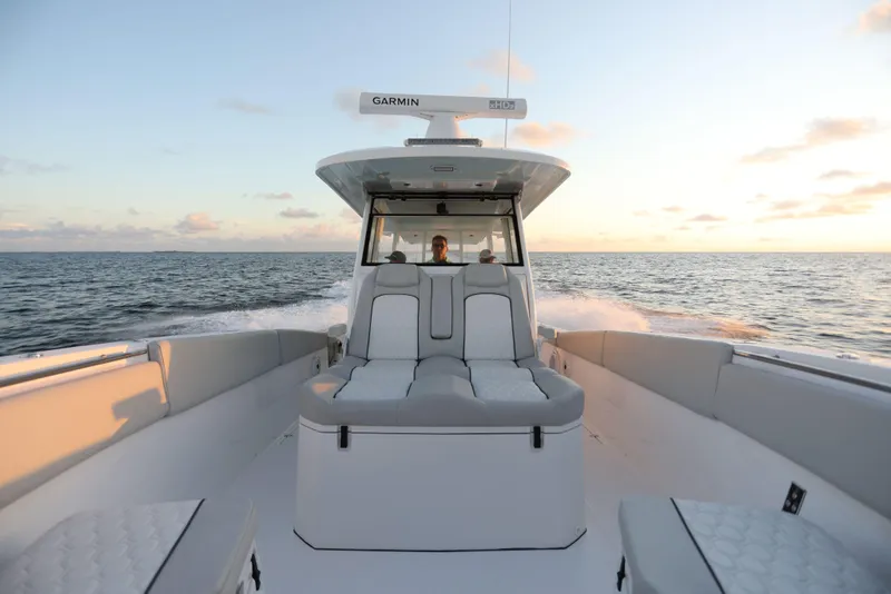 Slide: The Image of 2025 Sea Fox 368 Commander Center Console boat cruising on open water at sunset. - 21