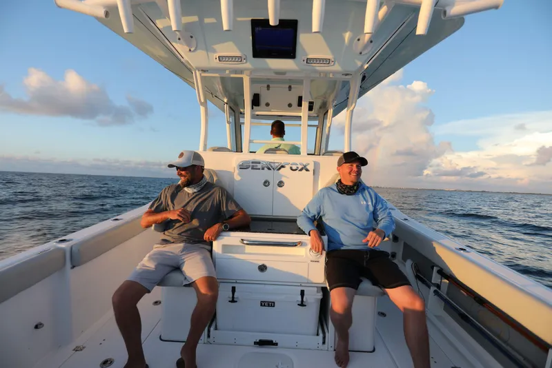 Slide: The Image of 2025 Sea Fox 368 Commander Center Console boat with passengers enjoying the ocean view. - 18