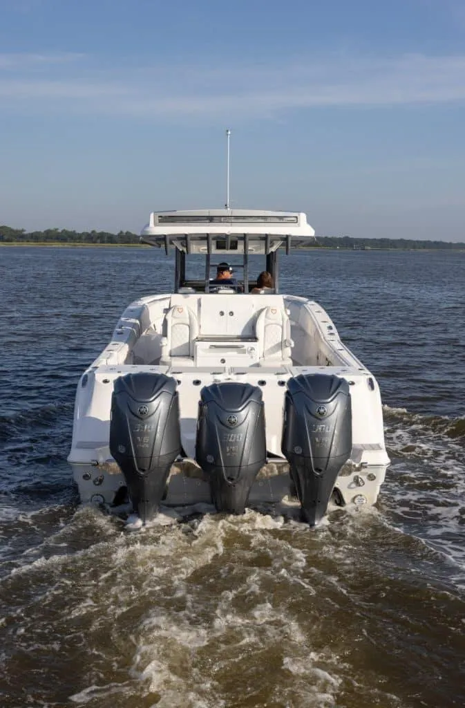 Slide: The Image of 2025 Sea Fox 368 Commander Center Console boat with triple outboard engines on water. - 3