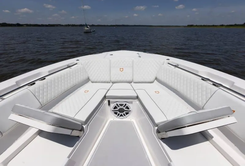 Slide: The Image of 2025 Sea Fox 368 Commander Center Console boat with luxurious seating on calm waters. - 7