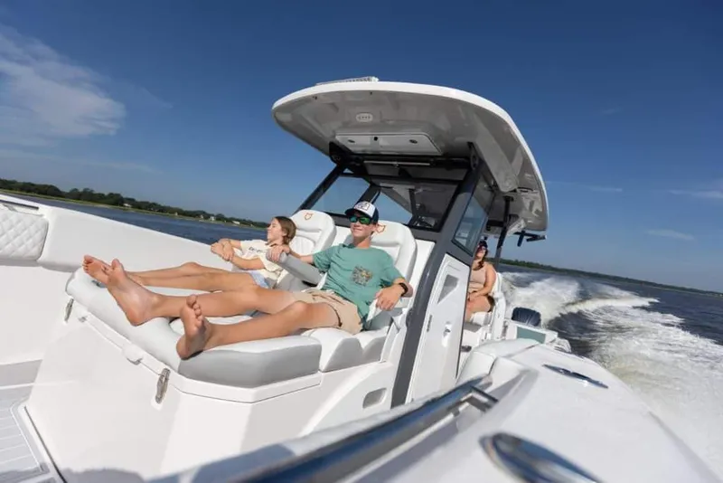 Slide: The Image of 2025 Sea Fox 368 Commander Center Console cruising with passengers relaxing. - 9