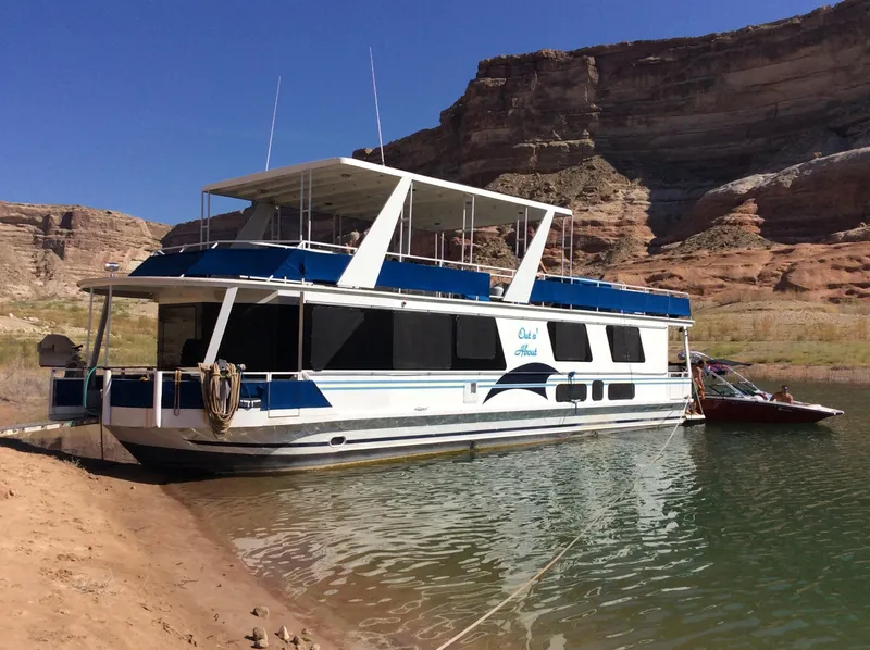 Slide: The Image of 2001 Skipperliner houseboat docked in a scenic canyon lake. - 4