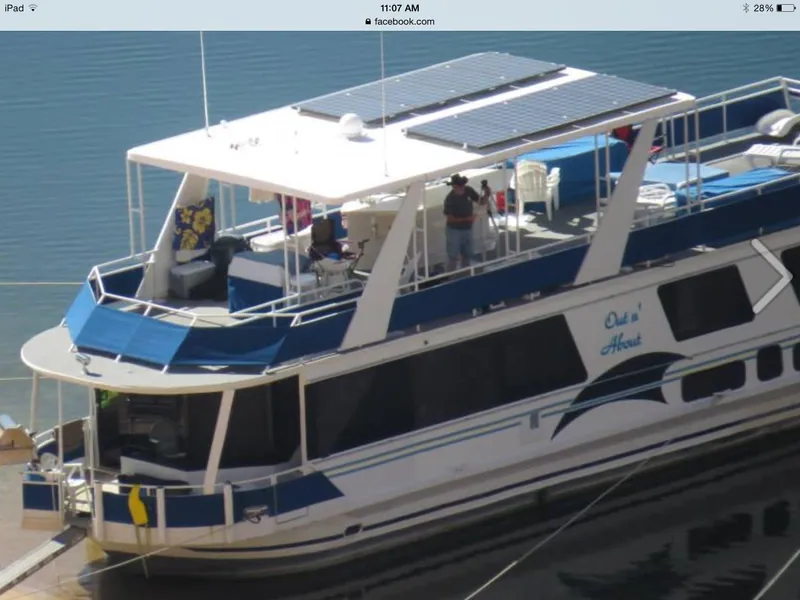 Slide: The Image of 2001 Skipperliner houseboat docked with people on the upper deck. - 5