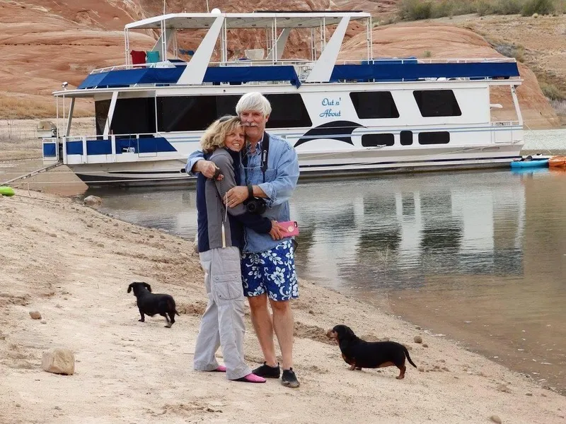 Slide: The Image of Couple with dogs by 2001 Skipperliner houseboat on sandy shore. - 7