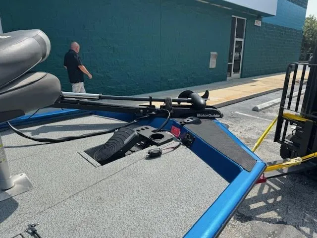 Slide: The Image of 2021 Lund 1875 Renegade boat with MotorGuide trolling motor in a parking lot. - 7