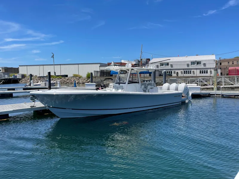 The Image of 2022 Regulator 34 boat docked in marina under clear blue sky. - 1