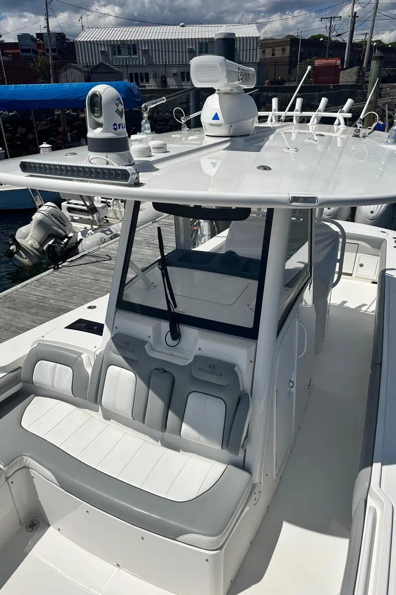 Slide: The Image of 2022 Regulator 34 boat with sleek design and advanced navigation equipment. - 12