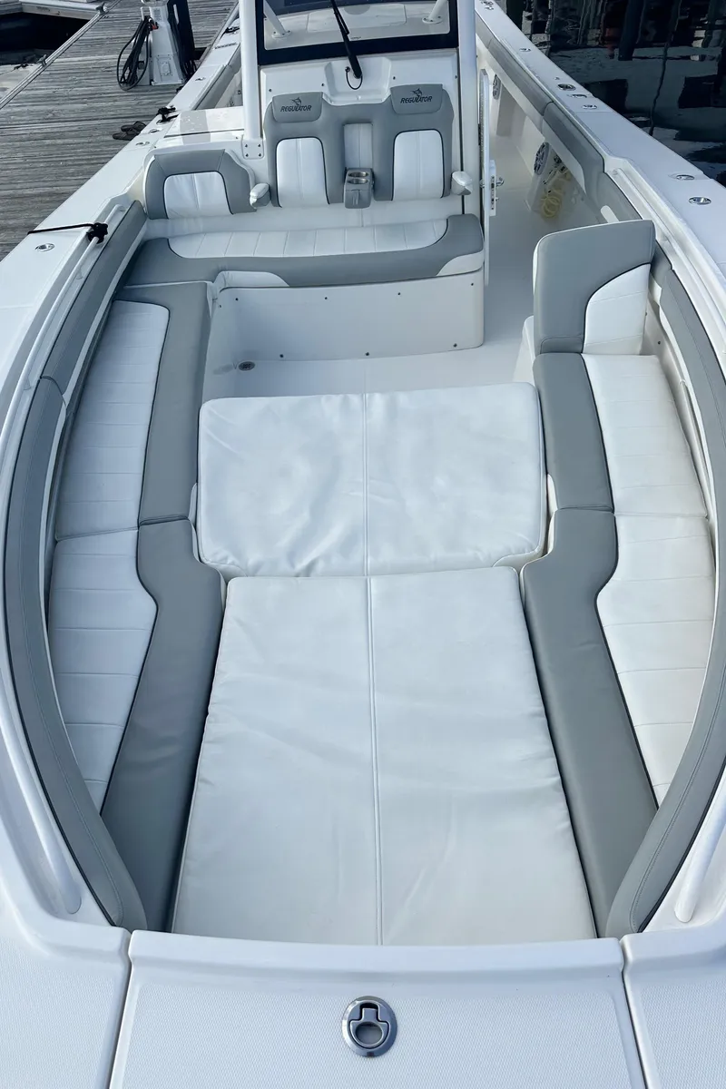 Slide: The Image of 2022 Regulator 34 boat interior with white and gray seating. - 19