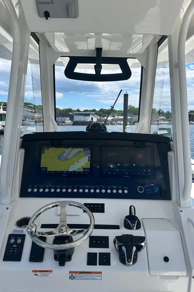 Slide: The Image of 2022 Regulator 34 boat helm with advanced navigation system and steering wheel. - 21