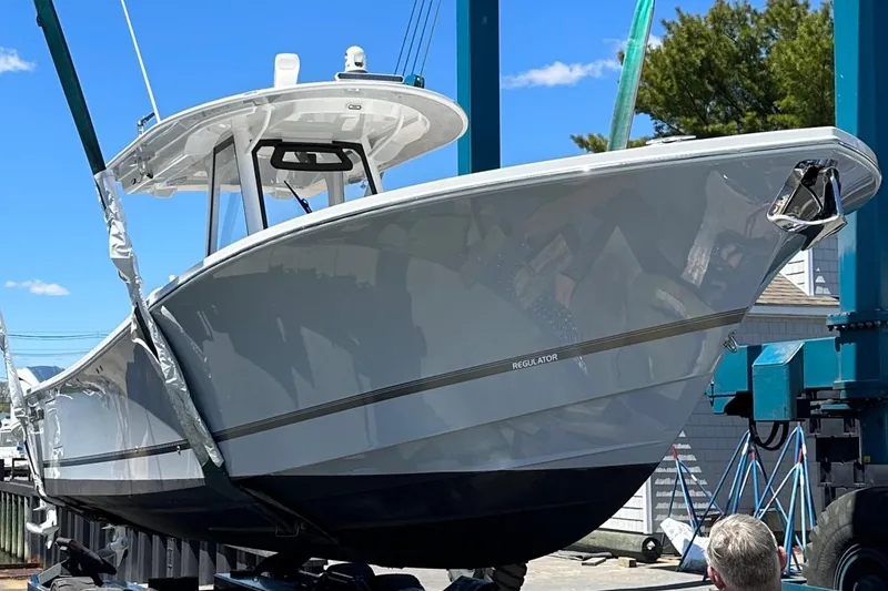 Slide: The Image of 2022 Regulator 34 boat on lift, showcasing sleek design and modern features. - 26
