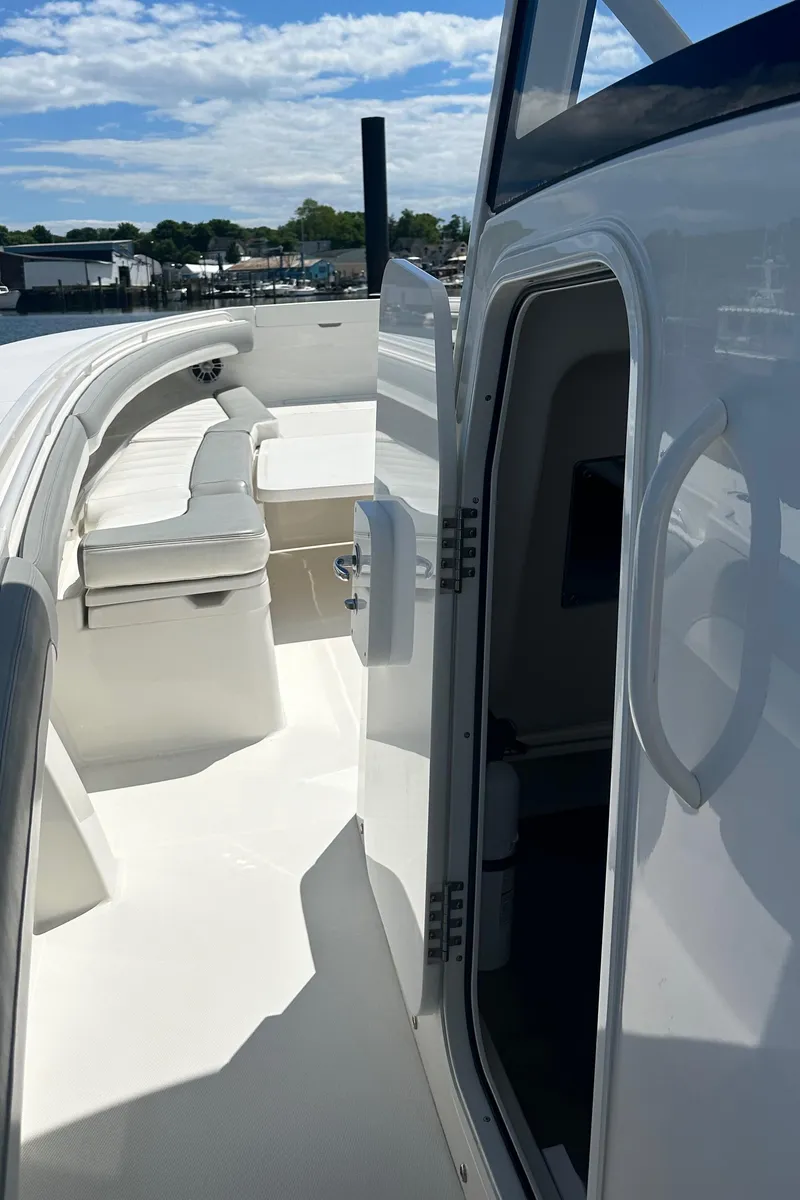 Slide: The Image of 2022 Regulator 34 boat interior with open cabin door and seating area. - 5
