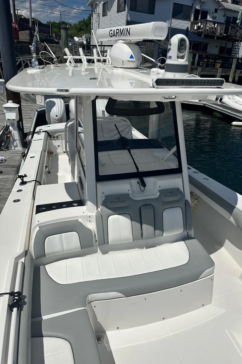 Slide: The Image of 2022 Regulator 34 boat docked, featuring a sleek design and advanced Garmin navigation system. - 10