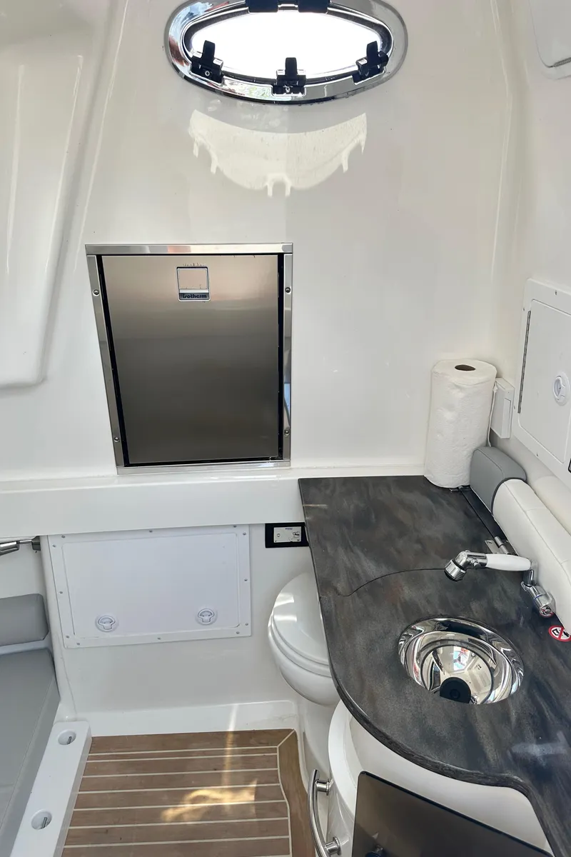 Slide: The Image of 2022 Regulator 34 boat interior with modern bathroom amenities and sleek design. - 17