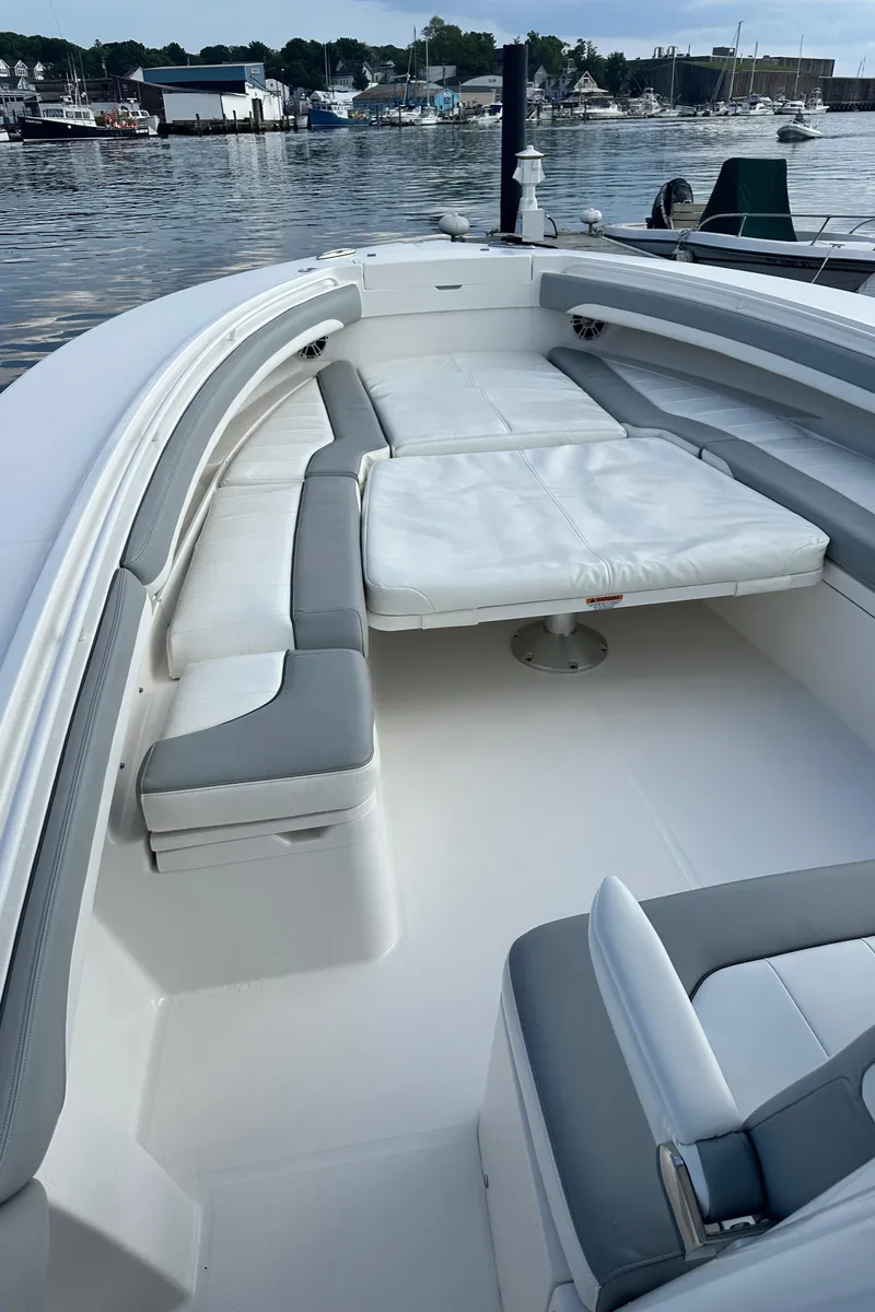 Slide: The Image of 2022 Regulator 34 boat with spacious seating, docked at a marina. - 20